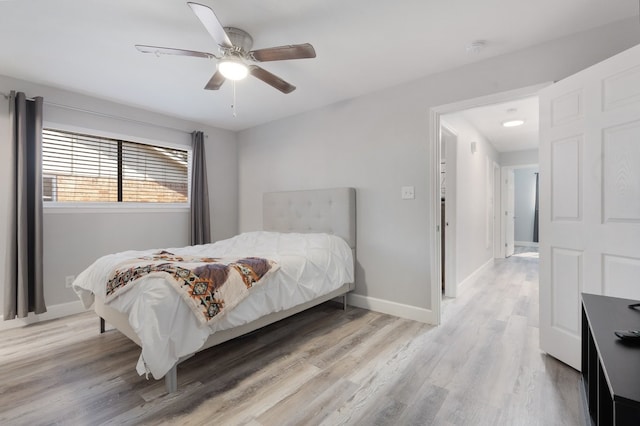 bedroom with ceiling fan and light wood-type flooring