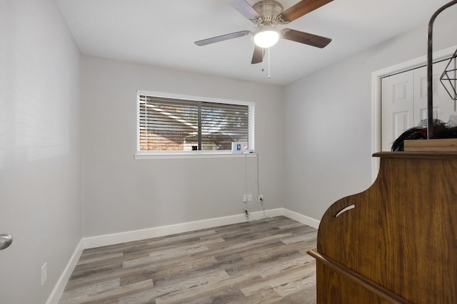 spare room featuring light wood-type flooring and ceiling fan