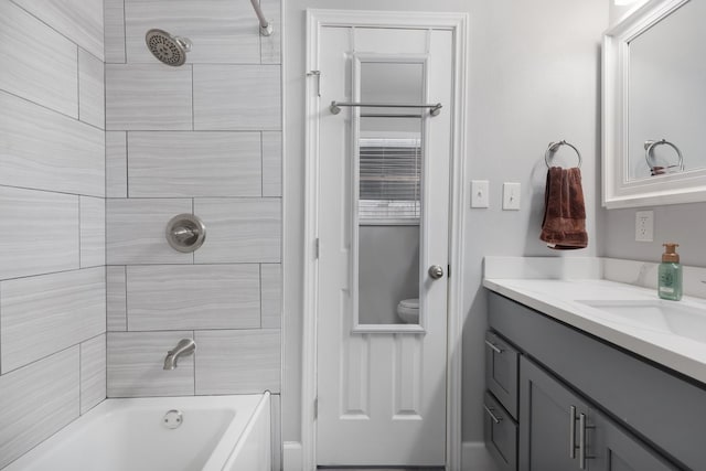 bathroom with vanity and tiled shower / bath combo