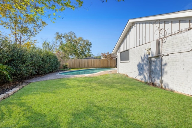 view of yard with a fenced in pool