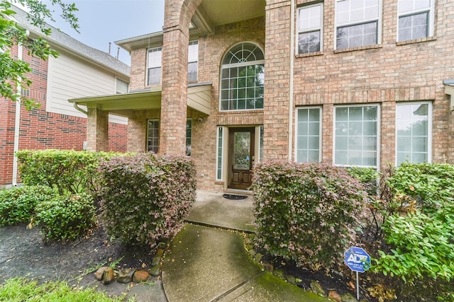 property entrance featuring brick siding