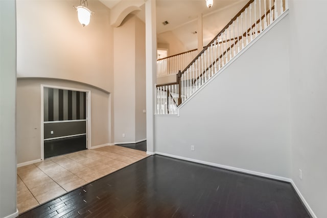 unfurnished living room with hardwood / wood-style flooring and high vaulted ceiling