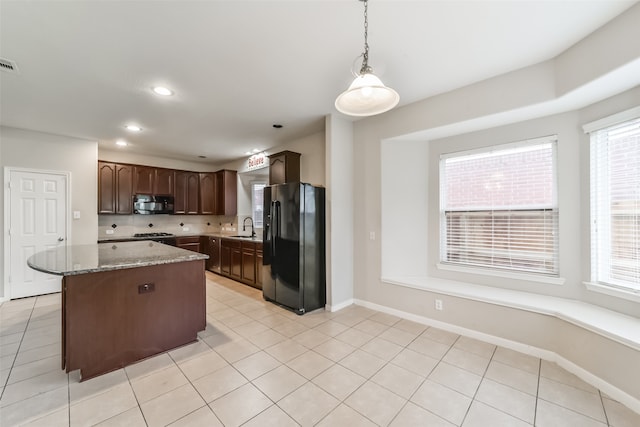 kitchen with pendant lighting, plenty of natural light, black appliances, and sink