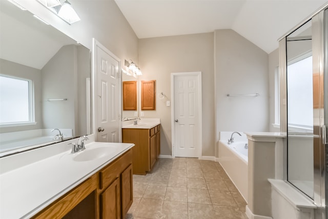 bathroom with vanity, tile patterned floors, independent shower and bath, and vaulted ceiling with skylight