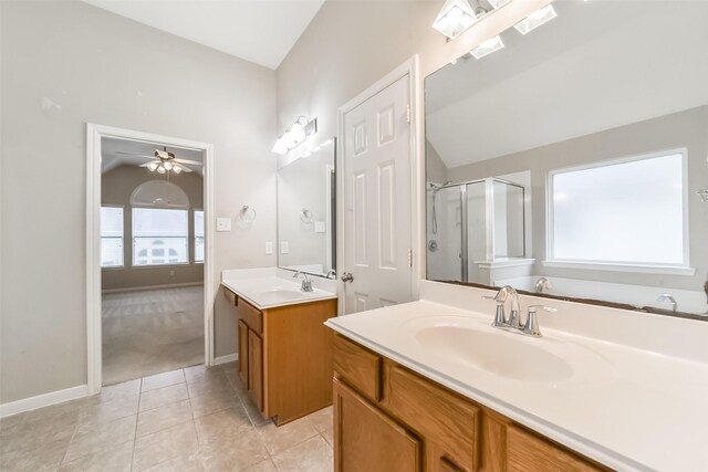 bathroom featuring tile patterned floors, vanity, an enclosed shower, and vaulted ceiling