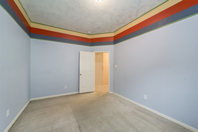 spare room with carpet and a textured ceiling