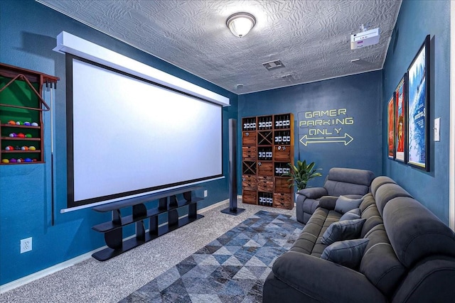 cinema room featuring baseboards, visible vents, dark colored carpet, and a textured ceiling
