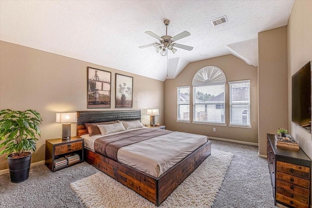 bedroom with visible vents, a textured ceiling, baseboards, carpet flooring, and lofted ceiling