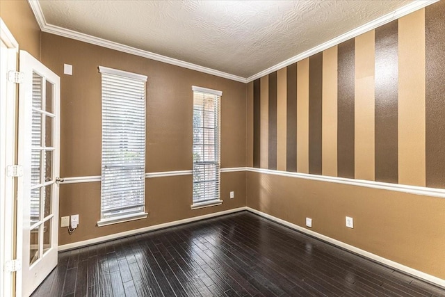 empty room with baseboards, wood-type flooring, a textured ceiling, and ornamental molding