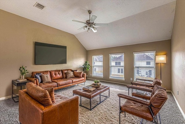 living room with visible vents, baseboards, lofted ceiling, carpet flooring, and a ceiling fan