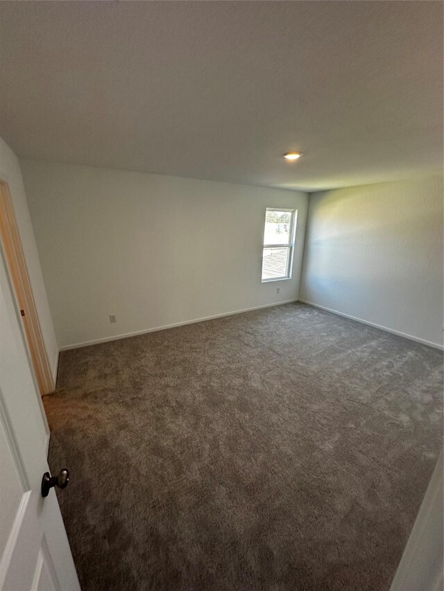 empty room with dark carpet