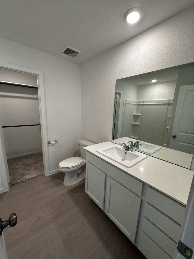 bathroom featuring hardwood / wood-style floors, vanity, and toilet