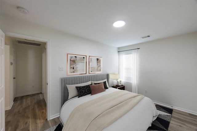 bedroom featuring dark hardwood / wood-style flooring