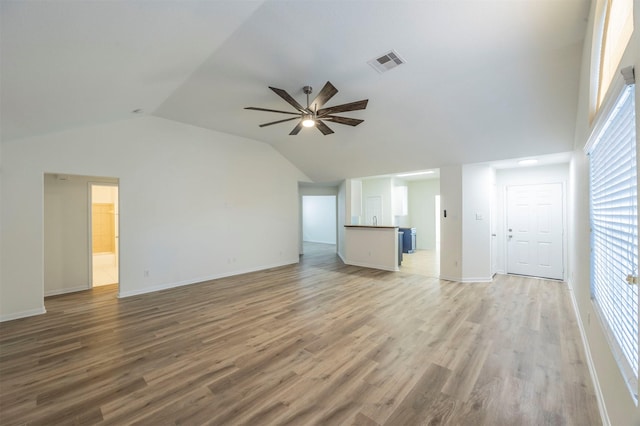 unfurnished living room featuring a ceiling fan, light wood-type flooring, visible vents, and lofted ceiling