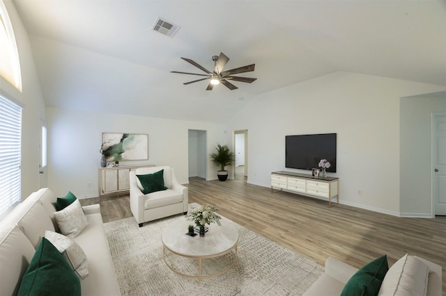 living room featuring lofted ceiling, ceiling fan, and light hardwood / wood-style flooring