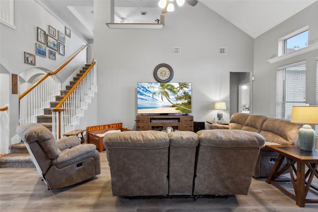 living room featuring ceiling fan, high vaulted ceiling, and hardwood / wood-style flooring