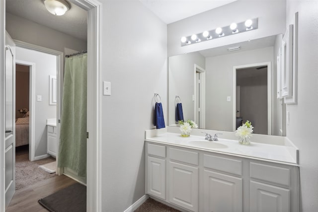 bathroom with hardwood / wood-style floors and vanity