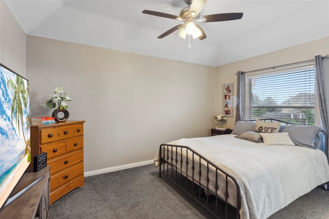 bedroom featuring ceiling fan, dark carpet, and lofted ceiling