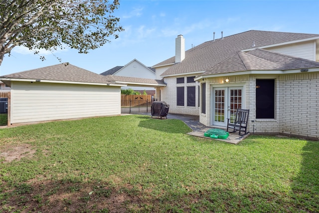 back of house with a lawn