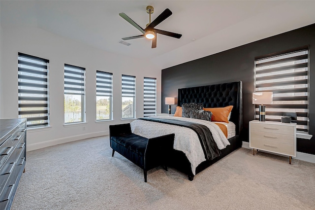 bedroom featuring light carpet and ceiling fan