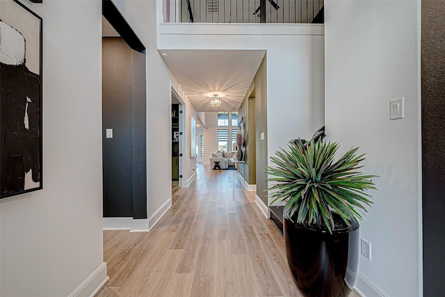 hallway with light hardwood / wood-style flooring