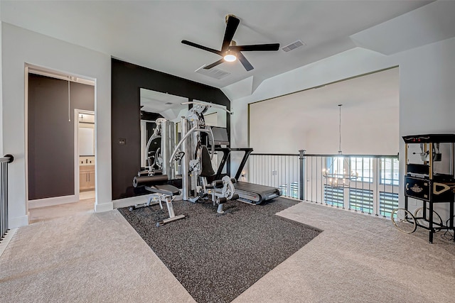 exercise area featuring ceiling fan with notable chandelier, light carpet, and lofted ceiling