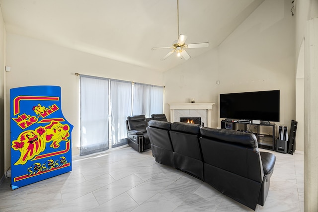 living room with ceiling fan, high vaulted ceiling, and a premium fireplace