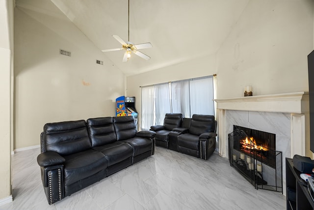 living room featuring high vaulted ceiling, ceiling fan, and a high end fireplace