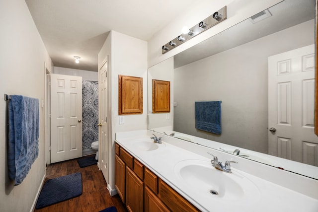 bathroom featuring hardwood / wood-style floors, vanity, and toilet