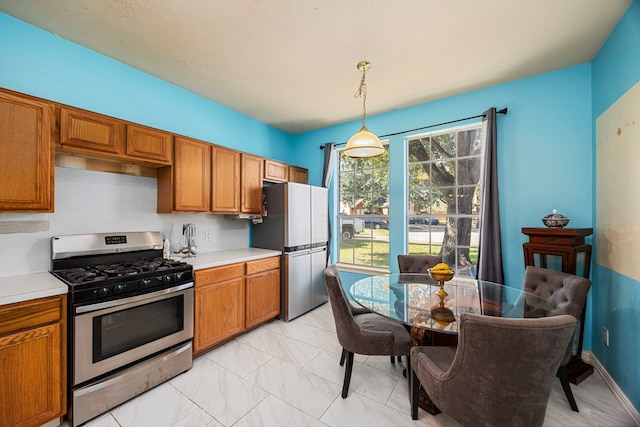 kitchen with decorative light fixtures and stainless steel appliances