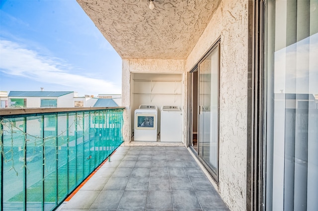 balcony with washer and clothes dryer