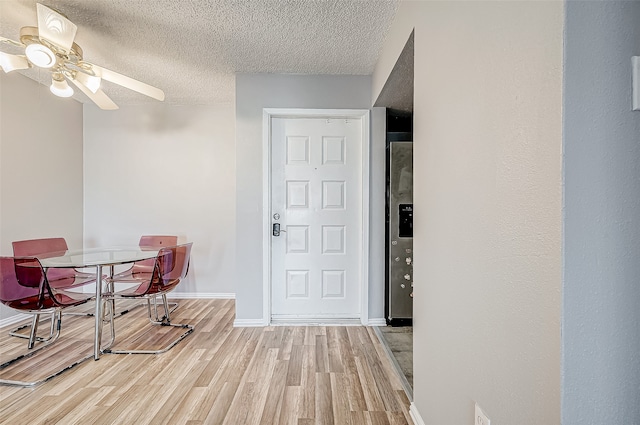 dining room with hardwood / wood-style flooring, ceiling fan, and a textured ceiling