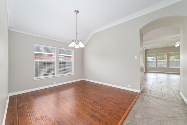 empty room featuring hardwood / wood-style floors, ceiling fan with notable chandelier, and ornamental molding