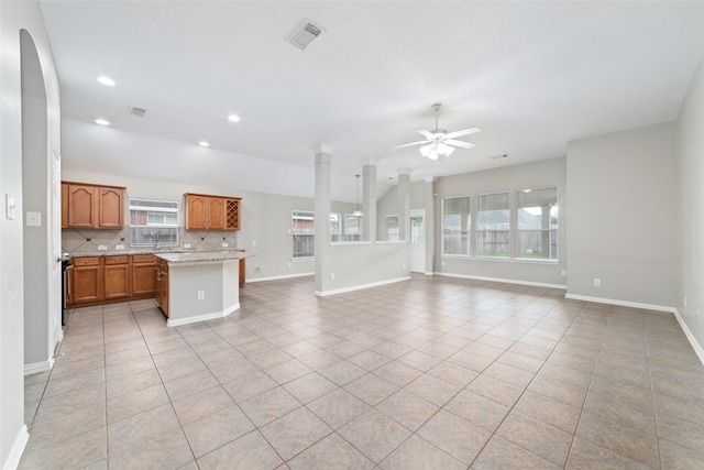 kitchen featuring tasteful backsplash, plenty of natural light, and light tile patterned floors