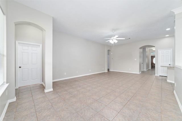 spare room with ceiling fan and light tile patterned flooring