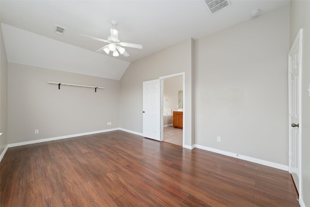 unfurnished bedroom with dark hardwood / wood-style flooring, ensuite bath, ceiling fan, and lofted ceiling