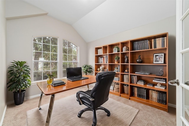 home office featuring light colored carpet and vaulted ceiling