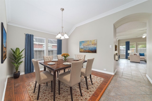 dining room with ornamental molding, a healthy amount of sunlight, ceiling fan with notable chandelier, and light wood-type flooring