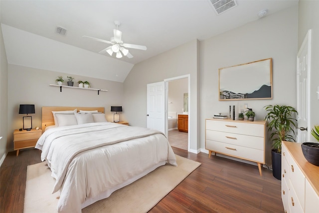 bedroom featuring ensuite bath, ceiling fan, dark hardwood / wood-style floors, and vaulted ceiling