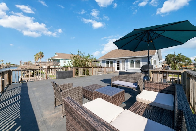 wooden deck featuring an outdoor living space, grilling area, and french doors