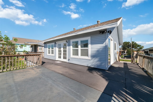 rear view of house featuring french doors