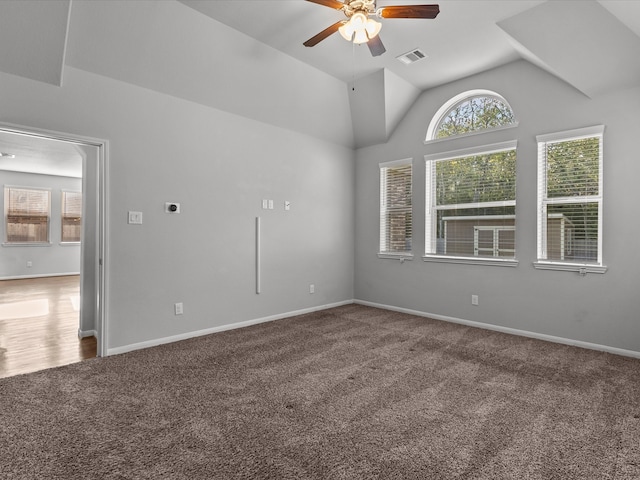 empty room featuring carpet, ceiling fan, and vaulted ceiling