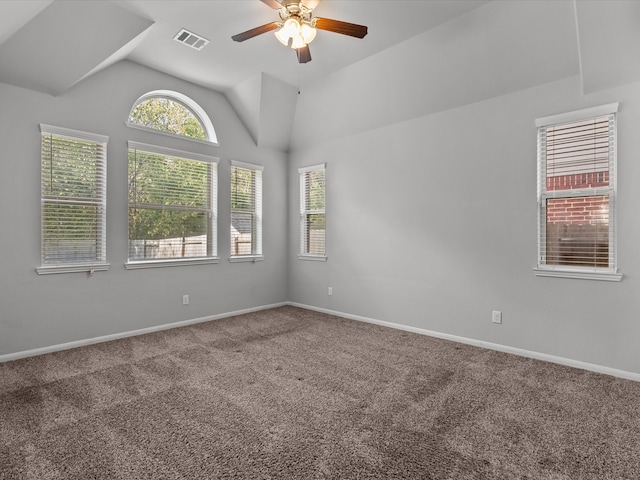 carpeted spare room with vaulted ceiling and ceiling fan