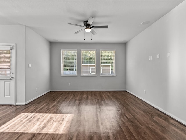 empty room featuring ceiling fan and dark hardwood / wood-style flooring