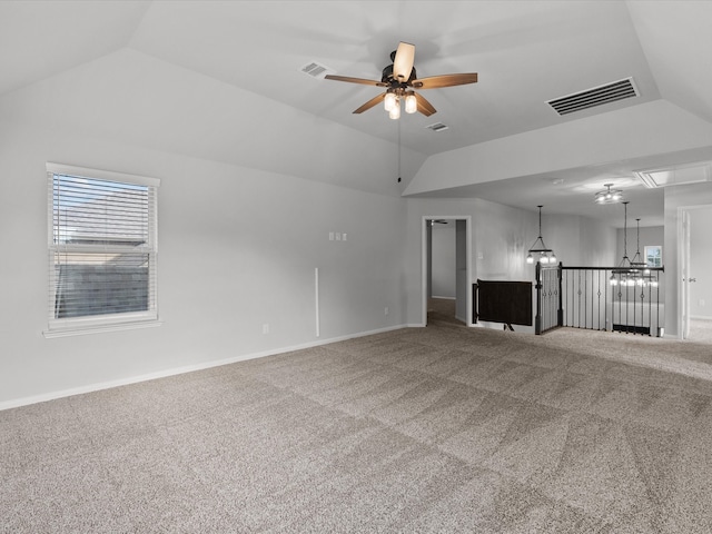 unfurnished living room with carpet, vaulted ceiling, and ceiling fan