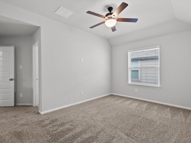 carpeted spare room with ceiling fan and lofted ceiling