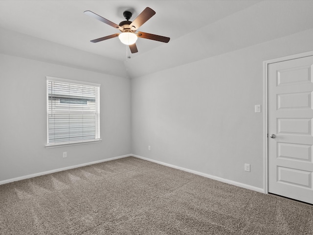 carpeted empty room featuring ceiling fan and vaulted ceiling