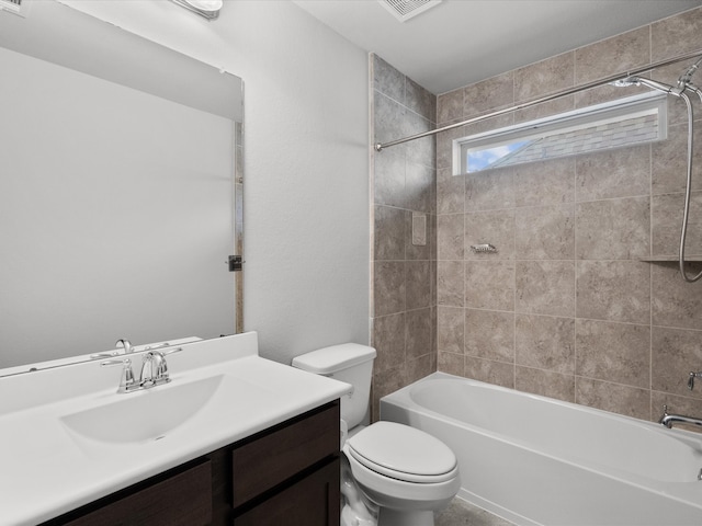 full bathroom with vanity, toilet, and tiled shower / bath