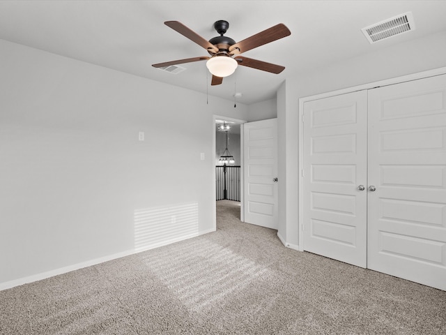 unfurnished bedroom with ceiling fan, carpet floors, and a closet