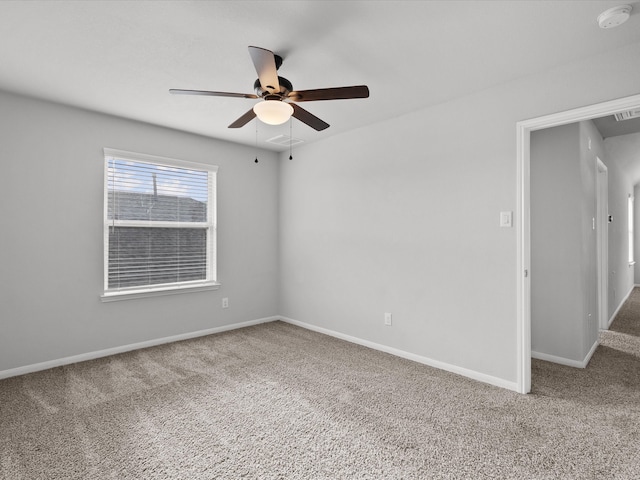 spare room featuring carpet and ceiling fan